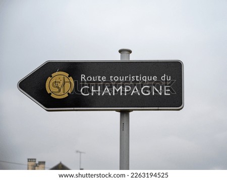Low season in winter in Champagne wine making region near Reims, France. Road signes and places of destinations, Gran Cru village, black road sign english translation: tourists route of Champagne