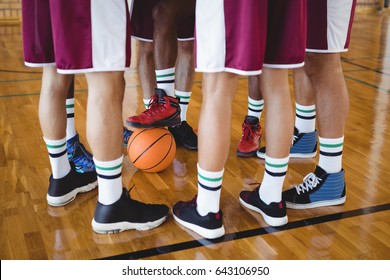 Low Section Of Basketball Players Forming A Huddle In The Court 