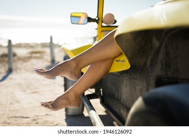 Low Section Of Caucasian Woman Sitting In Beach Buggy By The Sea. Beach Break On Summer Holiday Road Trip.