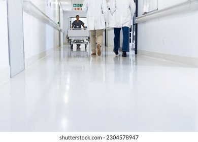 Low section of diverse doctors and medical worker in busy hospital corridor, copy space. Hospital, medical and healthcare services. - Powered by Shutterstock