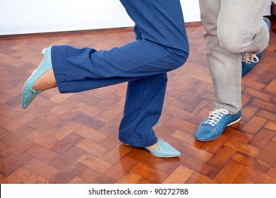 Low section of elderly couple dancing