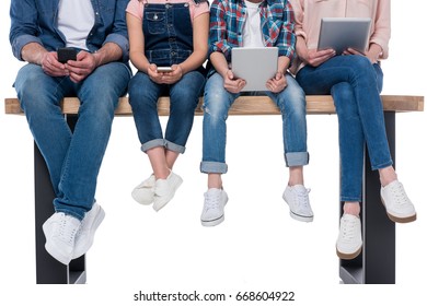 Low Section Of Family Using Different Digital Devices Isolated On White