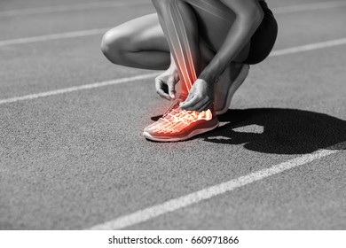 Low section of female athlete tying shoelace on track during sunny day - Powered by Shutterstock