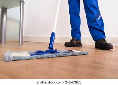 Low Section Of A Janitor Mopping Floor