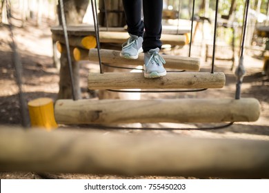 Low Section Of Kid Crossing Zip Line On A Sunny Day