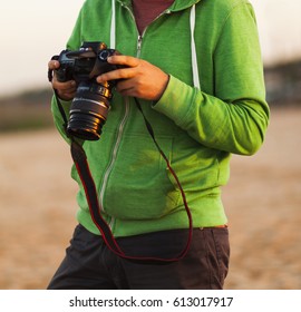 low section of a man holding a camera