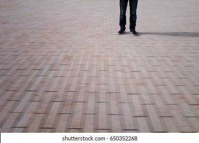 low section of a man standing on a blurry ground