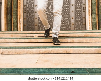 low section of a man walking down stairs