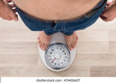 Low Section Of A Person Standing On Weighing Scale