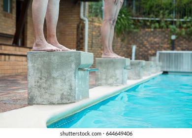 Low section of two senior women preparing to dive in pool - Shutterstock ID 644649406