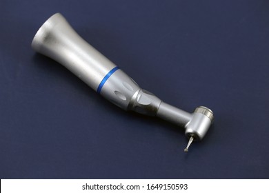 Low speed handpiece for dentistry on blue background
