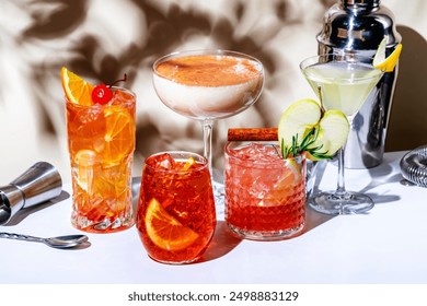 Low and strong alcohol cocktal drinks with gin, vodka, rum, vermouth, soda and juice. Beige background, hard light