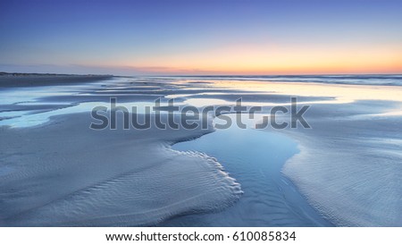 Low tide at the beach of Terschelling during sunset, the Netherlands