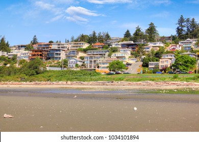 Low tide on the sandy beach at the popular quaint seaside community of White Rock surrounding  Semiahmoo Bay near Vancouver in British Columbia, Canada.