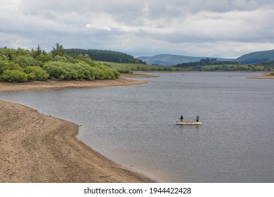 Low water level on a UK reservoir. Trout fishing in drought conditions during  summer