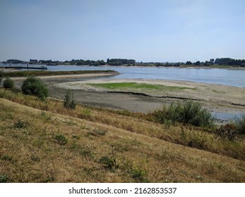 Low Water Level Of The River Rhine, Cracked Clay At The Riverbank. The Netherlands - Summer 2018