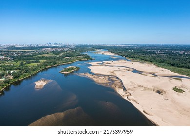 Low Water Level In Vistula River, Effect Of Drought Seen From The Bird's Eye Perspective. City Warsaw In A Distance.