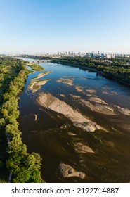 Low Water Level In Vistula River, Effect Of Drought Seen From The Bird's Eye Perspective. City Warsaw In A Distance.