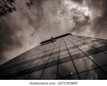 Low-Angle Perspective of a Modern Skyscraper Under a Dramatic Sky