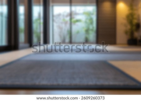 A low-angle perspective shows the patterned flooring of a modern interior with a glass window view.