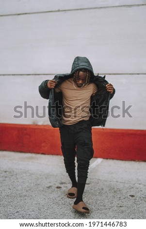 Similar – Black young man listening to music in a sunny day