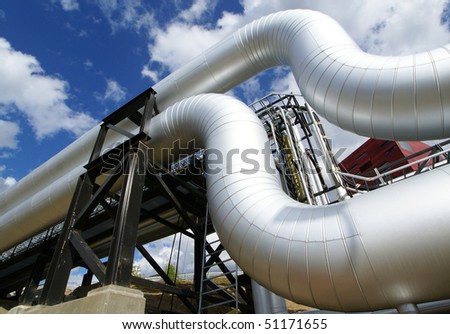 Low-angle shot of ladder and pipes refinery