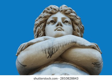 Low-angle view of the ancient marble statue of Aphrodite against a clear blue sky, symbolizing beauty, love, femininity, grace, and classical Greek mythology.