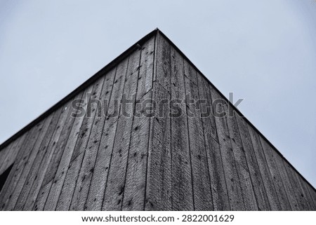 Low-angle view of a building clad in black charred timber using the traditional Shou Sugi Ban (Yakisugi) wood preservation technique, with minimalist architecture and copy space