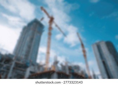 A low-angle view of a bustling construction site featuring towering cranes and unfinished skyscrapers against a bright blue sky with scattered clouds.