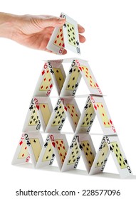 Low-angle View Of A Man Completing A House Of Cards