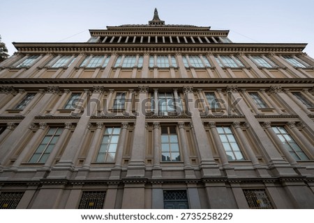 Low-angle view of the Neo-classical base of Mole Antonelliana in Turin, former synagogue and symbol of the city, at dusk.