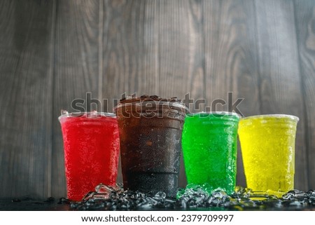 Low-angle view of A lot of Soft drinks in colorful and flavorful glasses on the table,Soft drinks or Carbonated beverages on ice