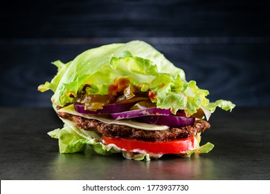 Low-carb Burger With Salad And Beef, Homemade Bunless All Beef Lean Hamburger Lettuce Wrap Which Is A Low Carb Alternative For Those On Paleo Diet, And Topped With Tomatoes And Onion