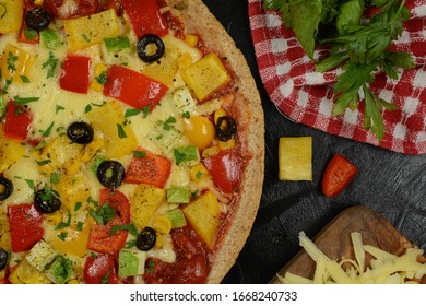 Low-Carb Keto Diet Pizza with Almond Flour Crust, Sugar-Free Tomato Sauce, Mozzarella, Bell Peppers and Olives. Served on a black background. - Powered by Shutterstock