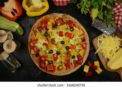 Low-Carb Keto Diet Pizza with Almond Flour Crust, Sugar-Free Tomato Sauce, Mozzarella, Bell Peppers and Olives. Served on a black background. - Powered by Shutterstock