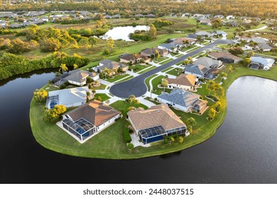 Low-density private homes at sunset. Rural street cul-de-sac dead end in residential suburbs with upscale suburban houses outside of Sarasota, Florida - Powered by Shutterstock