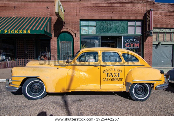 Lowell, Arizona, USA - December 13 2019: A\
vintage taxi cab restored with the logo of the fictional Broken\
Spoke Taxi Company.