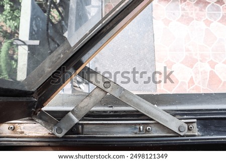 Lower casement silver window hinges.