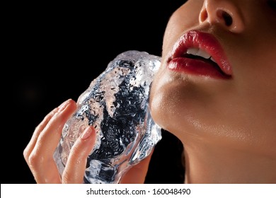 Lower Face Of A Woman Rubbing Ice Cube On Face.