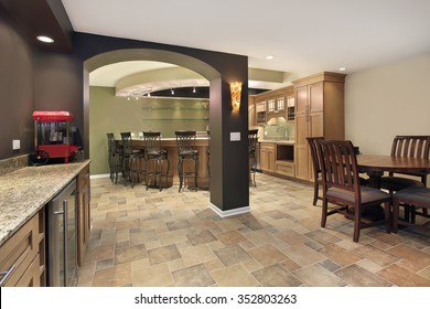 Lower Level Basement With Bar And Chairs