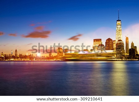 Lower Manhattan in New York City at sunrise with cruise ship passing by