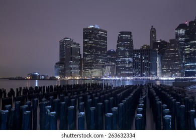 Lower Manhattan Skyline Night View From Brooklyn Bridge Park In New York City.