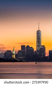 Lower Manhattan With The Statue Of Liberty And Freedom Tower At Sunrise