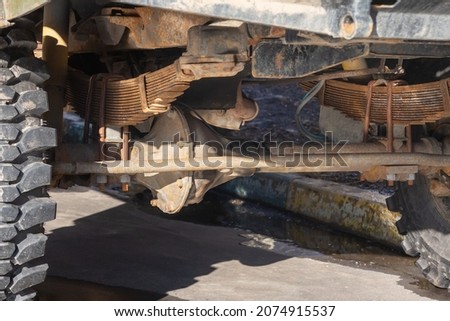 lower part of the car chassis and axle close-up, old and rusty jeep bottom