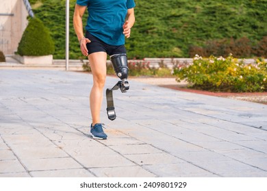 Lower part of a runner with prosthetic leg running along a park - Powered by Shutterstock