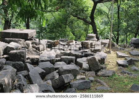 The lower part of the structure has a row of rounded, protruding shapes, which could be stylized carvings or architectural features.
