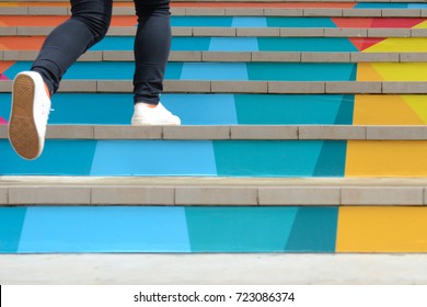 Lower part of teenage girl in casual shoe walking up outdoor colorful stair,teenage lifestyle successful concept - Shutterstock ID 723086374