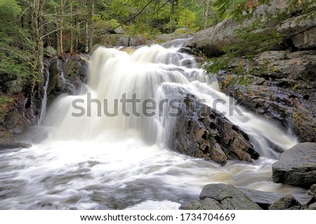 Lower Purgatory Falls. Breathtaking view of narrow rocky gorge and scenic waterfall along Purgatory Brook in southern New Hampshire.