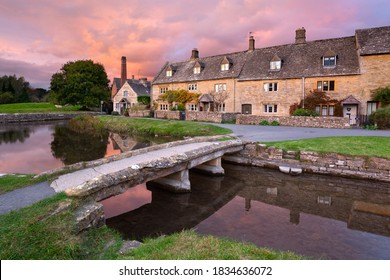 Lower Slaughter, Cotswolds, Gloucestershire, England - October 20th 2017: Stone bridge and cotswold stone cottages by the River Eye at sunset