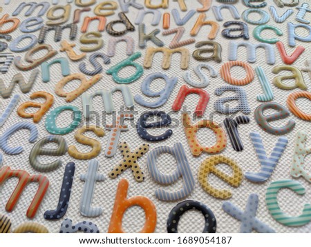 lowercase and multicolored alphabet letters on white background